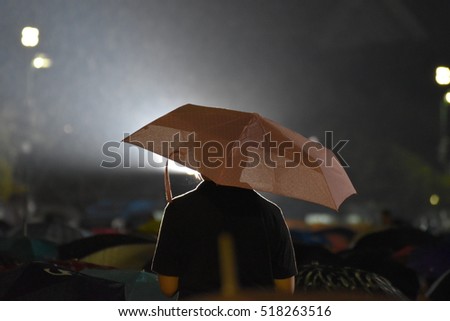a man standing in the falling rain