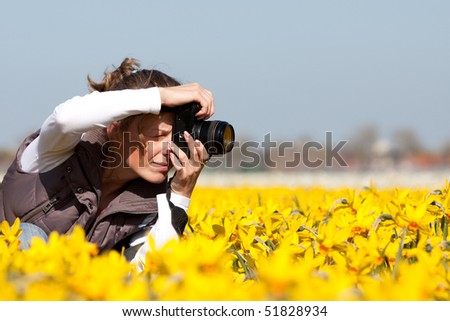 Girl photographer making pictures of flowers. Spring in the Netherlands