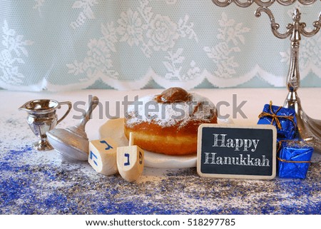Image of jewish holiday Hanukkah, donut and wooden dreidel (spinning top)


