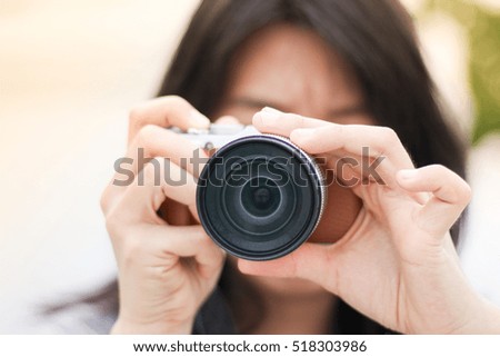 Thai Woman taking a photo in the temple during the day with bokeh and blur background, on sunlight day.