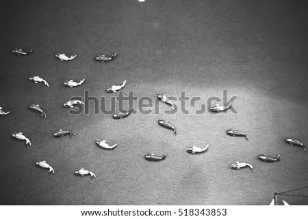 Decoration of the room in ocean theme, with fishes on the wall, and ship on the table, shallow focus, composition, black and white, modern, creative