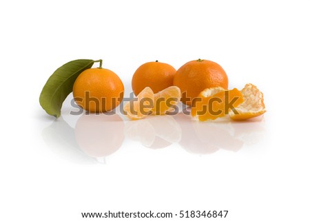 Three tangerines with leaf, peel and slices isolated on white background. Still-life picture taken in studio with soft-box.