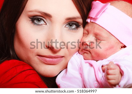 Family, childhood, motherhood, parenthood concept. Mother holding her littler newborn daughter.