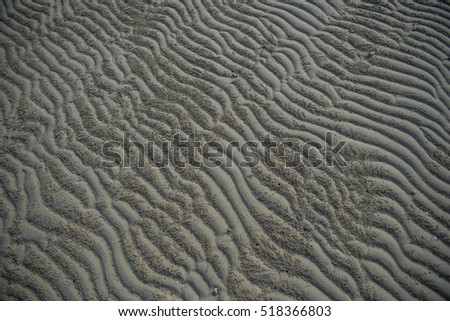pattern waves on the wet sand on the shore