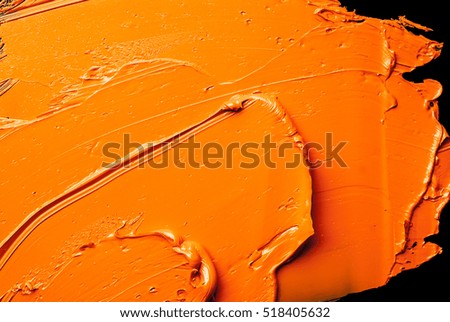 orange oil paint on the black palette