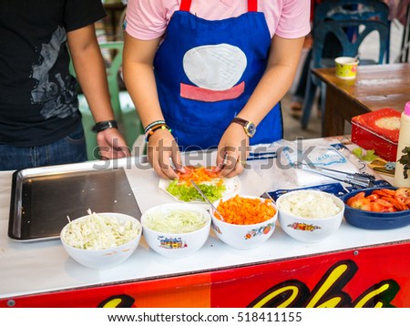 Asia woman cook salad vegetable at street market