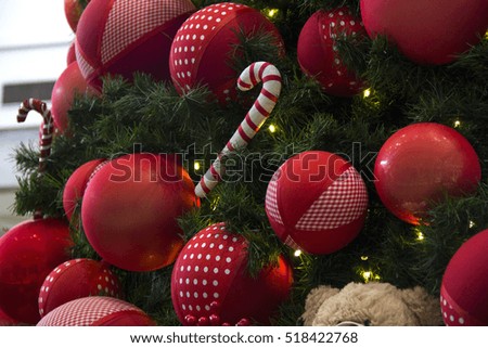 Christmas decoration with balls, flowers, baskets, tree with lights and gifts.