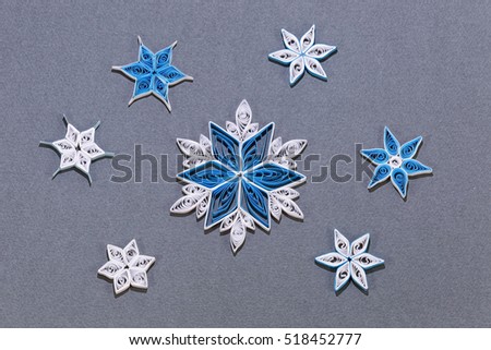 Christmas handmade paper quilling snowflakes on dark background