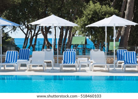 Hotel Poolside Chairs with Sea view. Summer shot