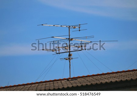 Antenna, antenna TV signal transmission, low-frequency antenna television countryside on home roof and sky blue
