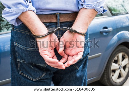Photo of man in handcuffs. Royalty-Free Stock Photo #518480605