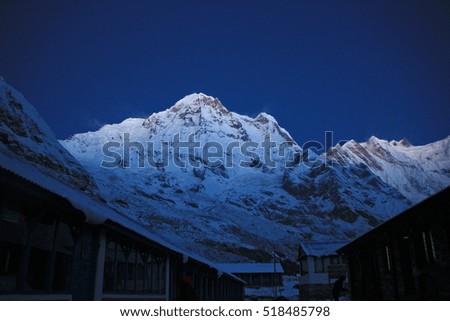 Before sunrise from Annapurna Base Camp (ABC) , Trekking on the trail in the mountains. Sport girl with backpack travels in Himalayas. Nepal trek to ABC. Female traveler near Annapurna Base Camp. 