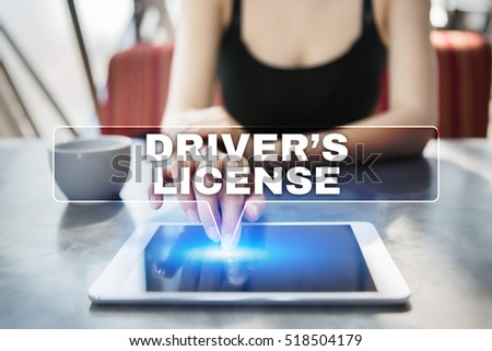 Woman using tablet pc and selecting driver?s license.