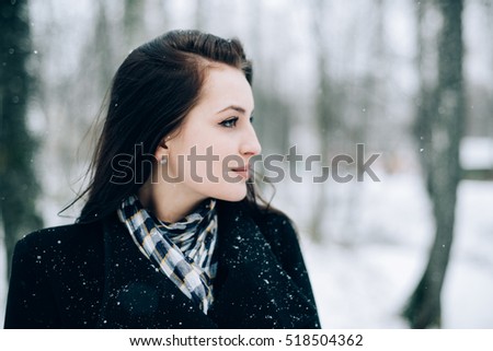 Woman winter snow nature portrait in black coat 