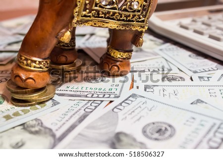 elephant, dollars and coins