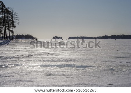 People walking on the ice and enjoying the sunny winter day
