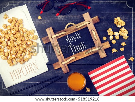 Movie Time Vintage Poster. Cinema Objects - Popcorn, 3d Glasses - on Black Wooden Background.