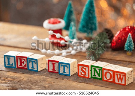 Let It Snow Written With Toy Blocks On Christmas Card Background With Copy Space.