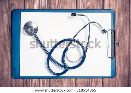 Doctors wooden table with tablet stethoscope and other stuff