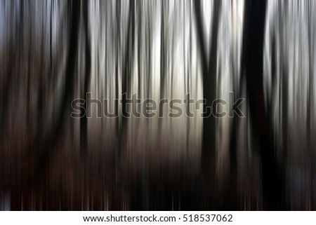 Abstract motion blur of trees in a creepy forest