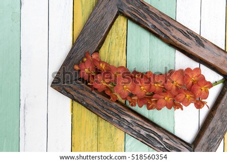A bouquet of orange orchids on old wooden background.Selective focus. Place for text.
