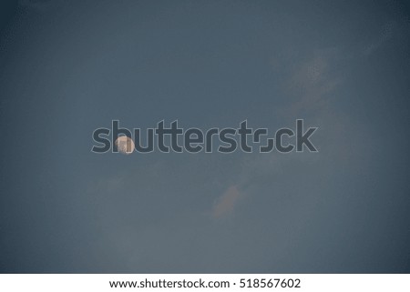 full moon background at the dusk on cloudy sky
