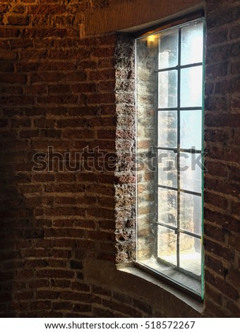Brick wall with a window in the castle of the city of Delft, the Netherlands