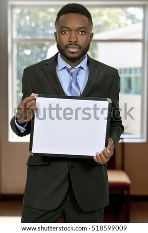 Young man holding up a blank sign