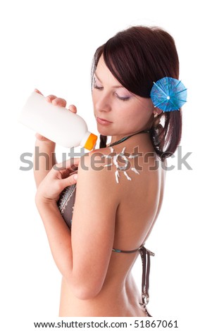 The beautiful young woman in bikini with the drawn sun on a shoulder on a white background.