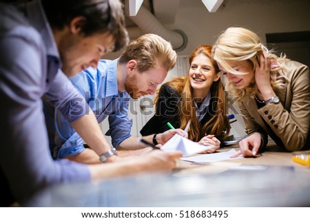 Team working on project together and sharing ideas in workshop Royalty-Free Stock Photo #518683495