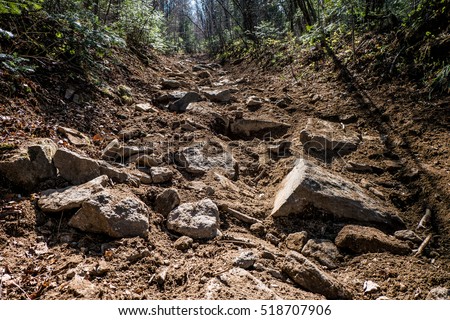 mountain path, early sunny morning hard road of stones Royalty-Free Stock Photo #518707906