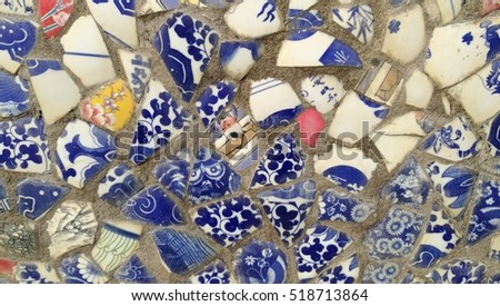 Old broken colorful vases, pots and plates used as a wall decoration motif in China