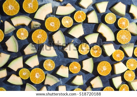 sweet melon cut in piece with oranges   