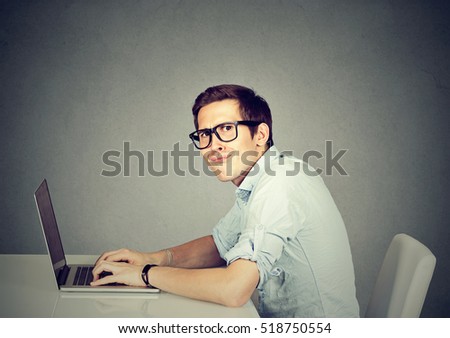 Nerdy man using a laptop computer