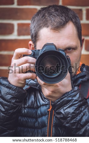 Portrait of a professional photographer with a camera