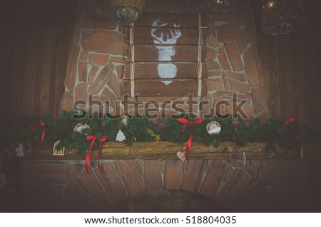 the picture of fireplace decorated for Christmas with a deer image background.
