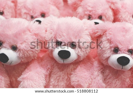 Pink teddy bear in a shop window. Gifts for people in love. Christmas bustle
