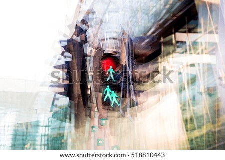 Multiple exposure effect image. Traffic light showing red and green against of modern office block building.  Business and modern life concept.