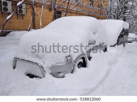 Cars under the snow. Roads are blocked