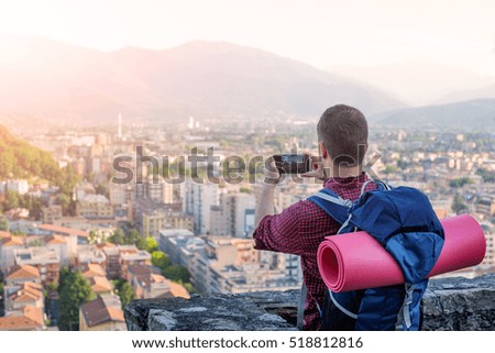 Man with backpack taking a picture
