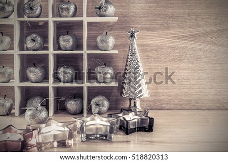 Christmas decorations. Vintage background. Silver apple, Christmas tree, star candle on a wooden background retro