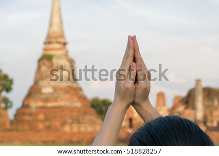 Close up people pray from Buddha statue to hope for help on sun set and bokeh background. Inspiration from help to hope, Put the palms of the hands together in salute.