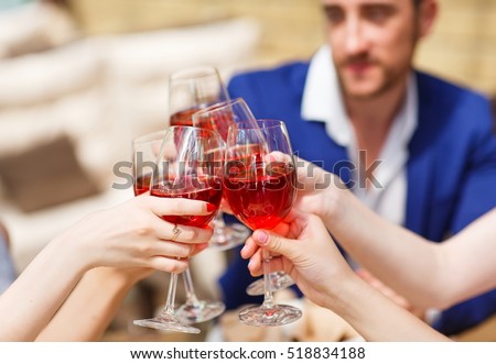 Friends drinking wine on the summer terrace.