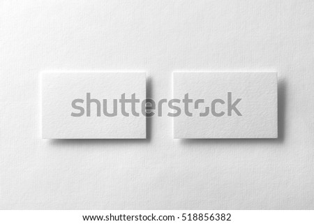 Mockup of two horizontal business cards at white textured background.