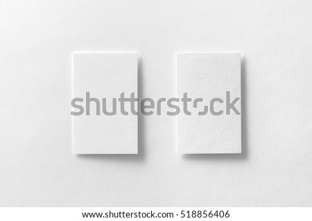 Mockup of two vertical business cards at white textured paper background. Royalty-Free Stock Photo #518856406