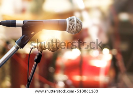 Microphone on concert stage background  Royalty-Free Stock Photo #518861188