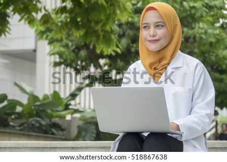 healthcare, medical and radiology concept - two doctors looking at laptop
