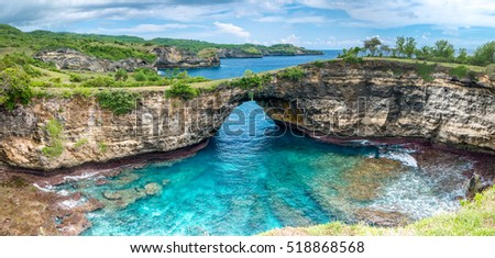 Rock coastline. Stone arch over the sea. Broken beach, Nusa Penida ,Indonesia. Royalty-Free Stock Photo #518868568