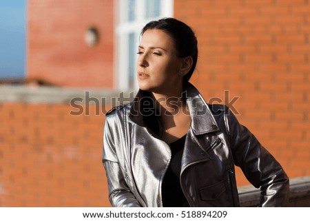 Stylish woman in silver leather jacket