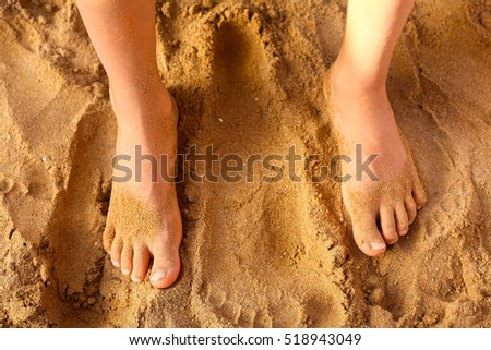 kids foot on the beach sand as a therapy against patypodia flat foot